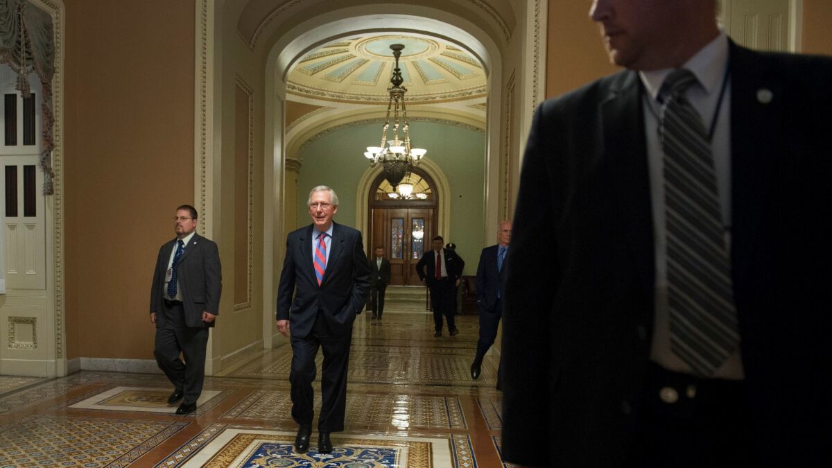 Senate Majority Leader Mitch McConnell (R-Ky.) walks from the Senate Chamber to his office on Capitol Hill in Washington on July 27.