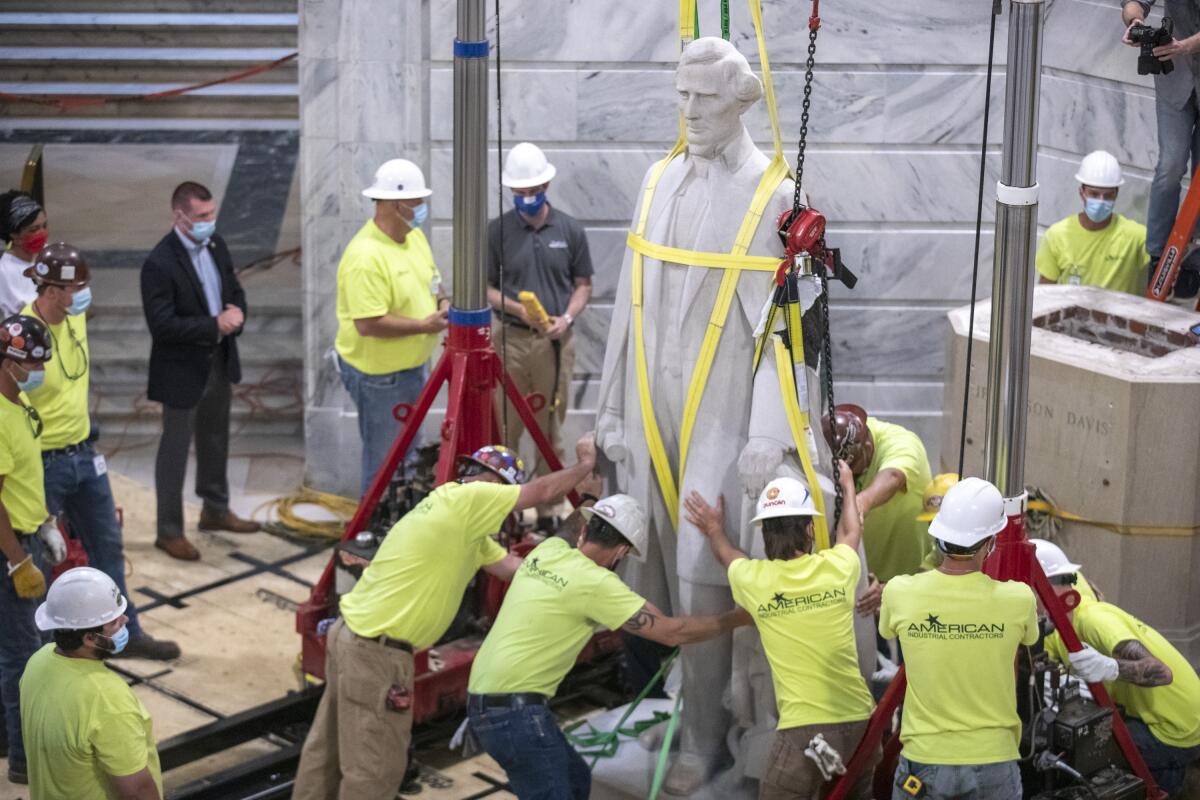 Workers prepare to remove the Jefferson Davis statue from the Kentucky state Capitol in Frankfort, Ky., on Saturday.