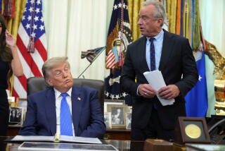 Health and Human Services Secretary Robert F. Kennedy Jr. speaks as President Donald Trump listens during a meeting to sign an executive order about vaccines, Monday, Aug. 10, 2026, in the Oval Office of the White House in Washington. (AP Photo/Jacquelyn Martin)