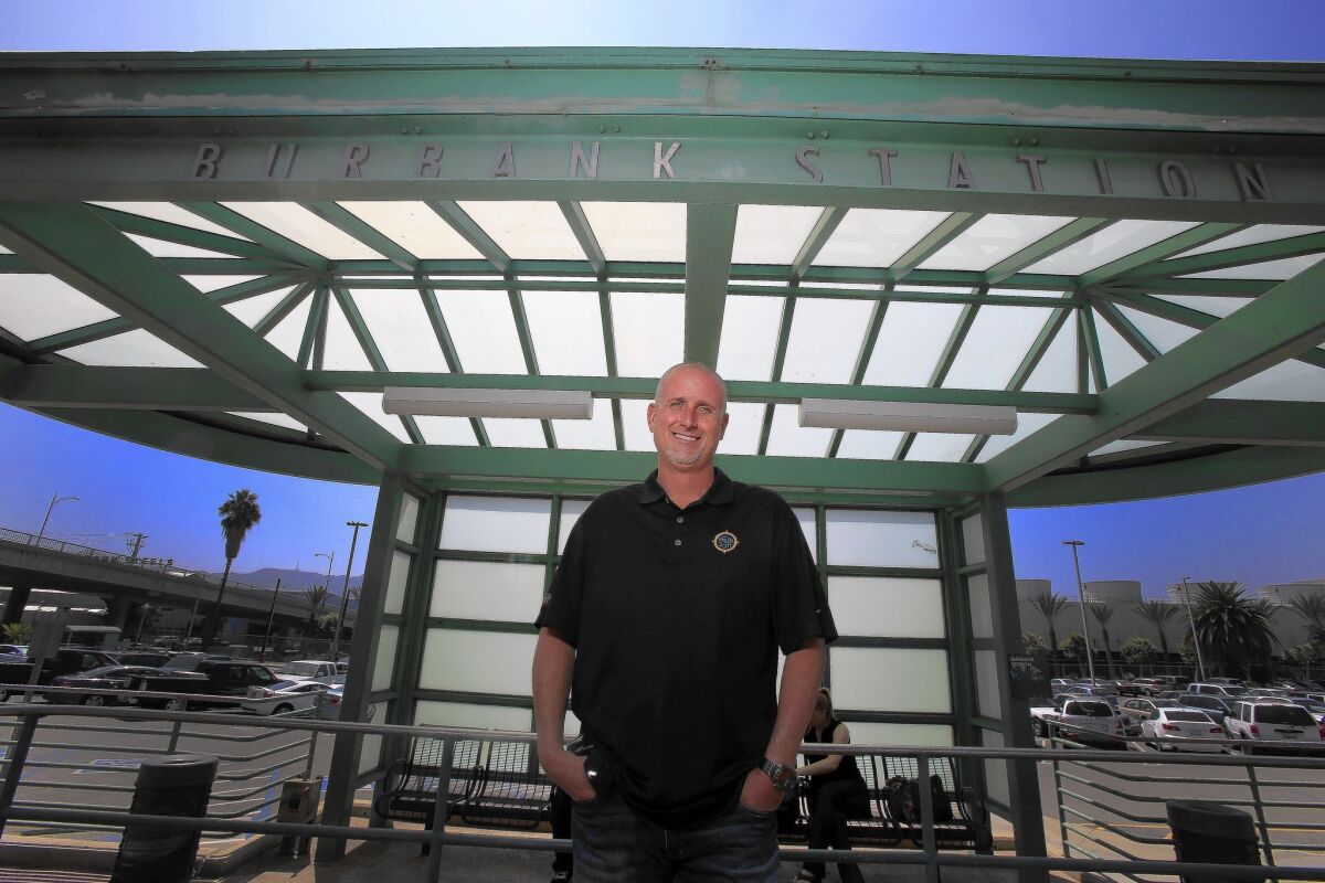 Sean Robb of Valencia stands on his former train platform at the Metrolink station in Burbank. Robb now drives himself to work instead of taking the train, which was often late, causing him to miss his bus connection to his job at Walt Disney Imagineering.