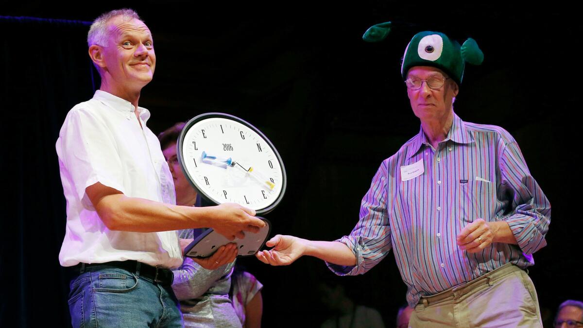Andreas Sprenger, left, accepts the Ig Nobel in medicine from Nobel laureate Richard Roberts for his research showing that you can sometimes relieve an itch on your right arm by scratching your left arm.