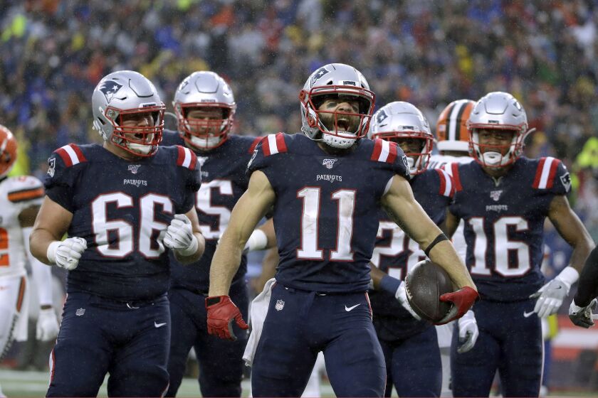 New England Patriots wide receiver Julian Edelman, center, celebrates his touchdown catch with teammates in the first half of an NFL football game against the Cleveland Browns, Sunday, Oct. 27, 2019, in Foxborough, Mass. (AP Photo/Steven Senne)