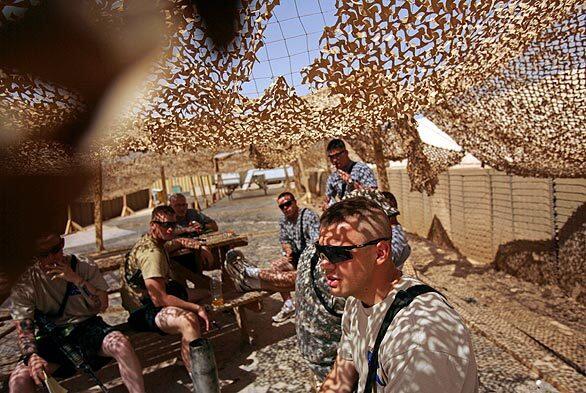 U.S. soldiers take a break in the shade at Forward Operating Base Warhorse in Baqubah.