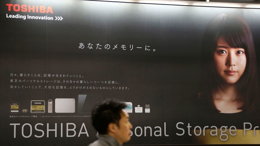 Toshiba stock tumbled 8% in Tokyo trading after its earnings weren't announced as scheduled. The company's chairman has resigned after a loss in its nuclear business.