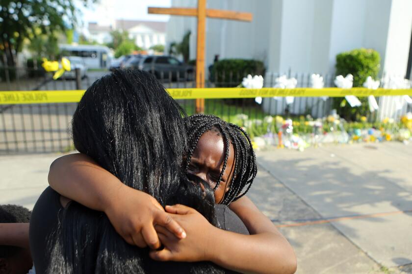 Kearston Farr hugs her daughter Taliyah, 5, at a memorial in front of the Emanuel AME Church in Charleston, S.C., on Friday.
