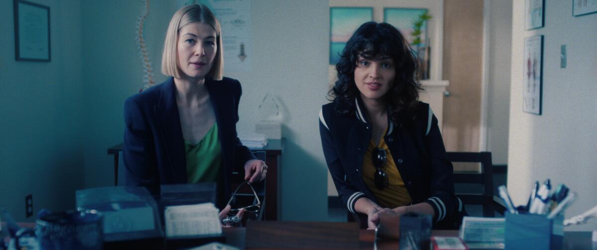 Rosamund Pike, left, as Marla and Eiza González as Fran in "I Care a Lot."