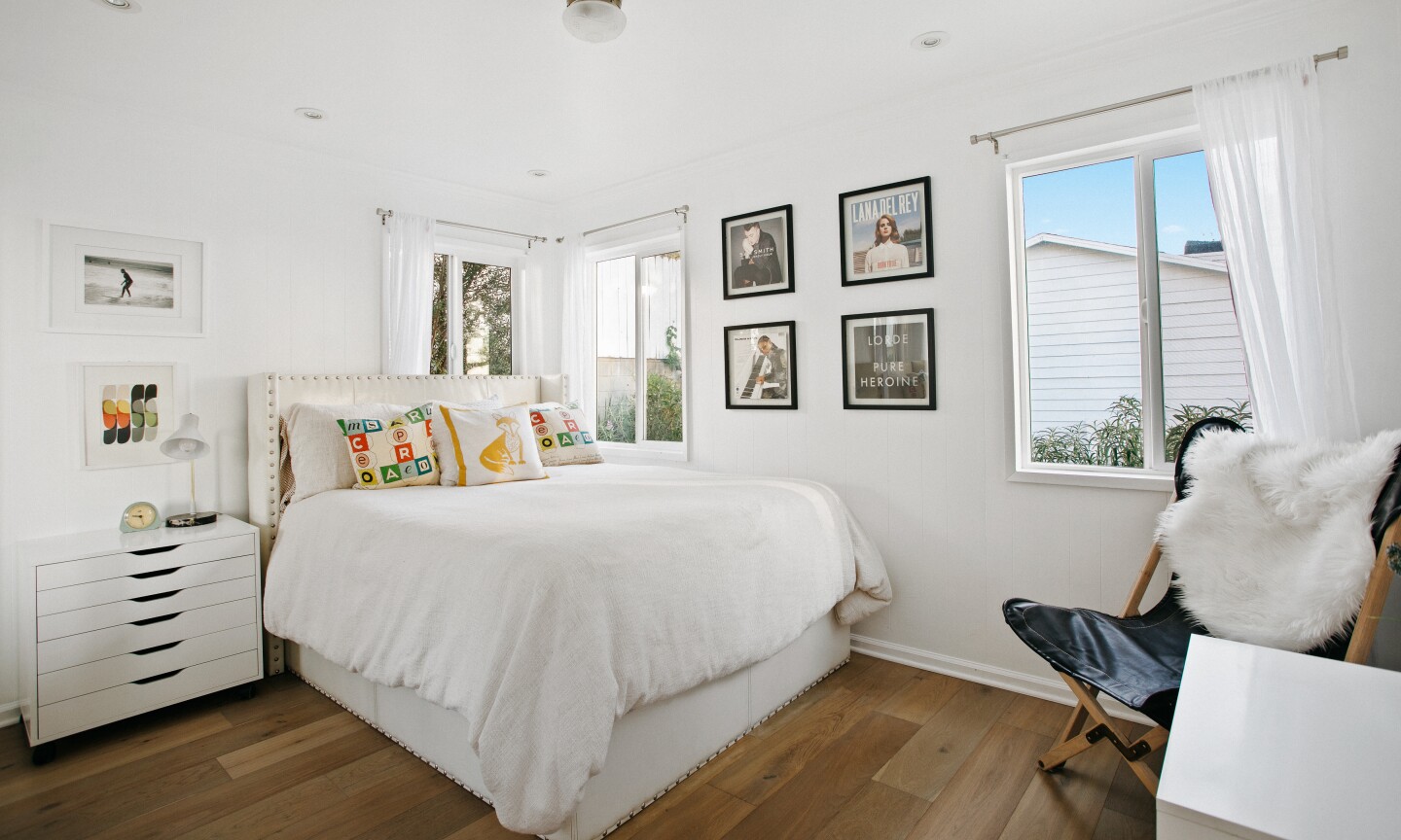 The property holds a two-bedroom home, detached studio, swimming pool, spa, basketball court and rooftop deck with a projector.