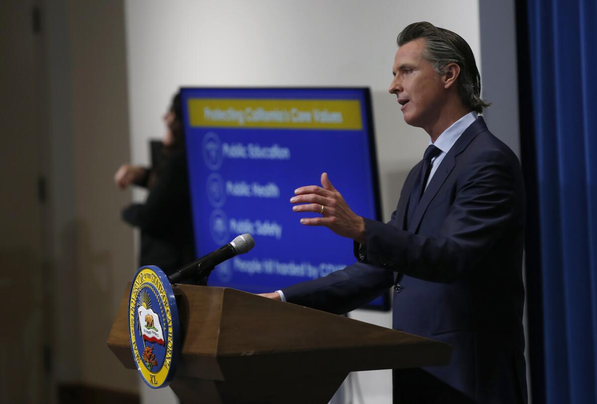 California Gov. Gavin Newsom discusses his revised 2020-21 state budget. To help offset a steep drop in the state's tax receipts, he proposes to tap money earmarked for cash benefits to the aged, blind and disabled who receive government assistance.