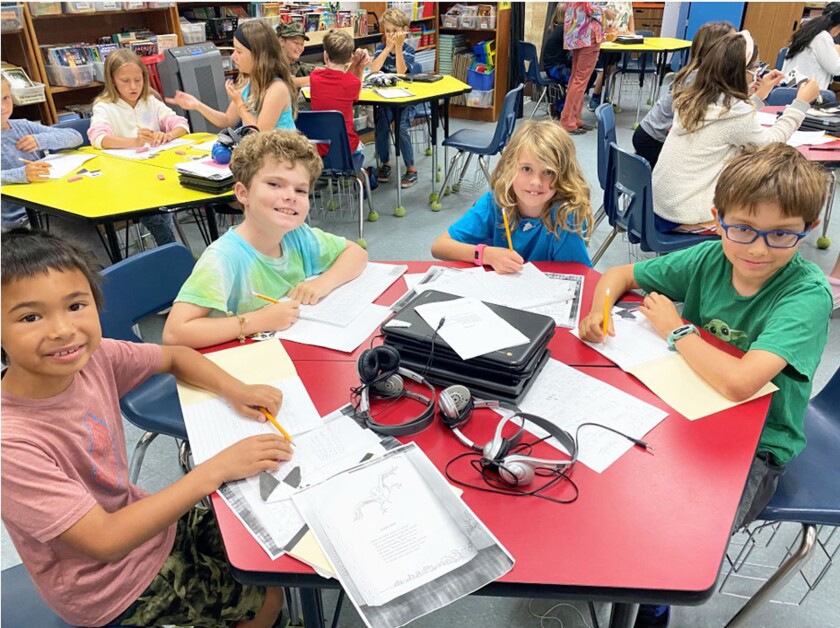 Third graders Blake White, Ace Pringle, Shelby Skiles and Casey Stoza working on a writing assignment.