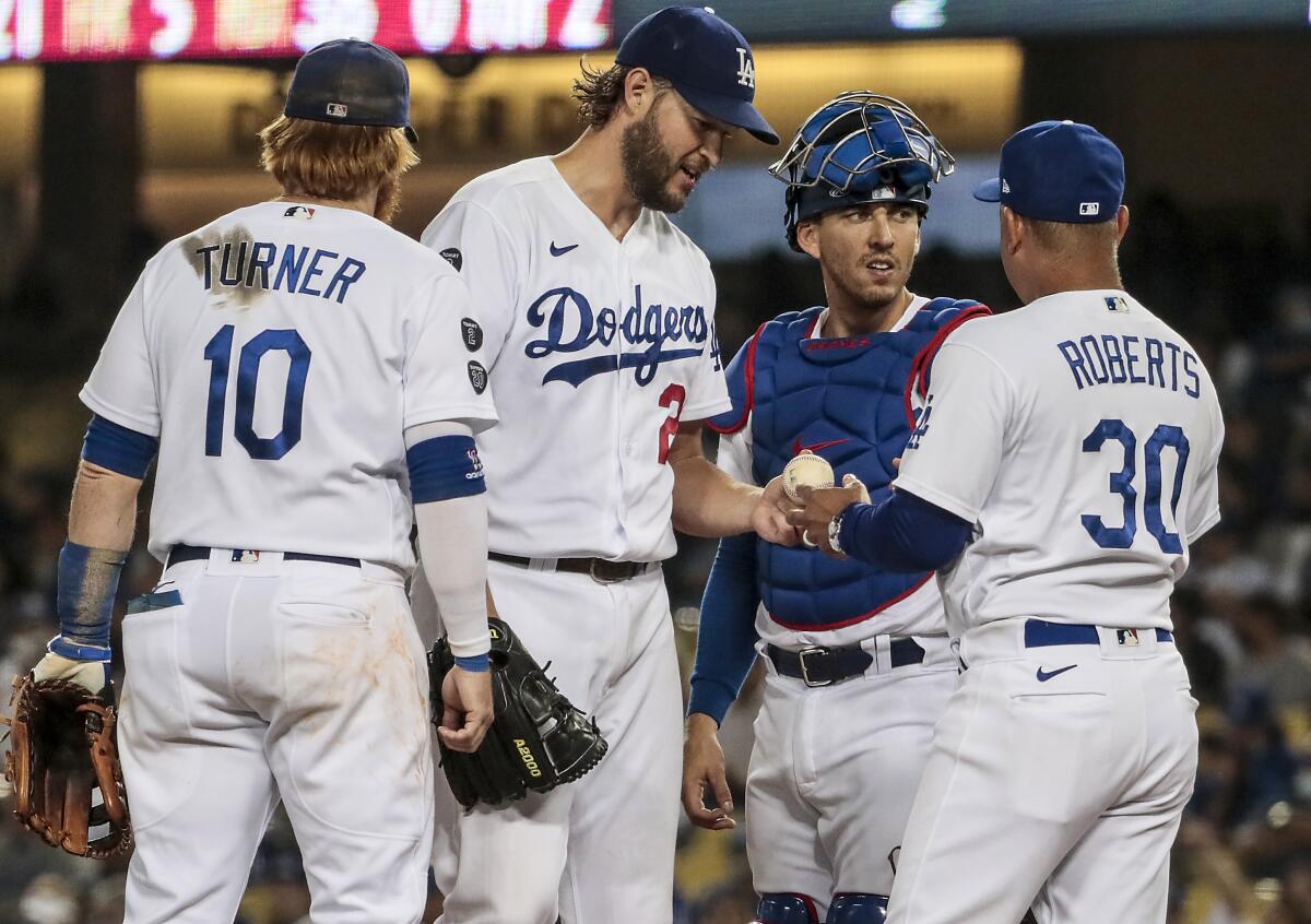 Dodgers manager Dave Roberts pulls pitcher Clayton Kershaw out of the game during the fifth inning Monday.