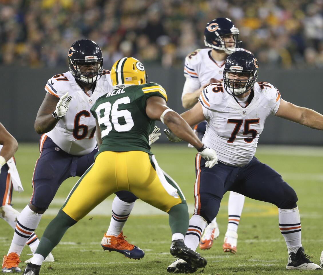 Chicago Bears offensive tackle Jordan Mills (67) and Chicago Bears offensive guard Kyle Long (75) protect their quarterback during the second quarter of their game against the Green Bay Packers at Lambeau Field on Nov. 4, 2013.
