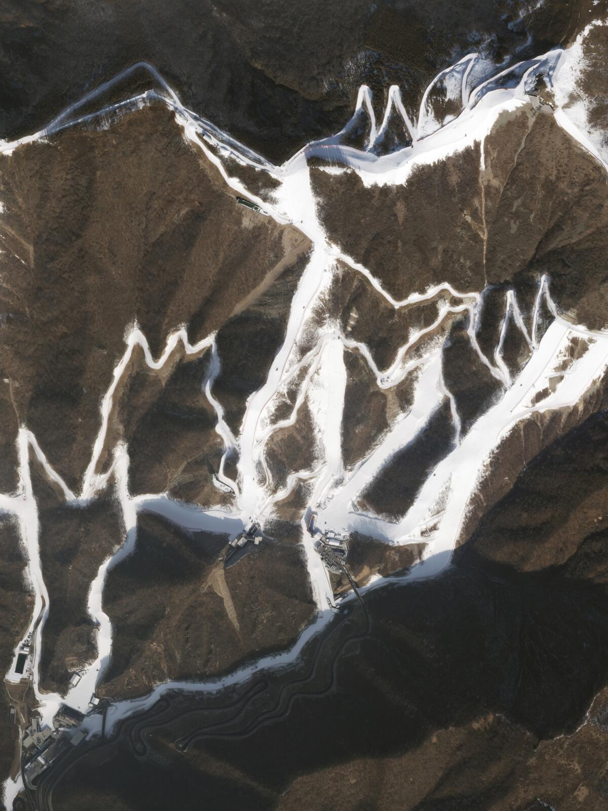 Manmade snow tracks run through the mountains for the 2022 Olympics.