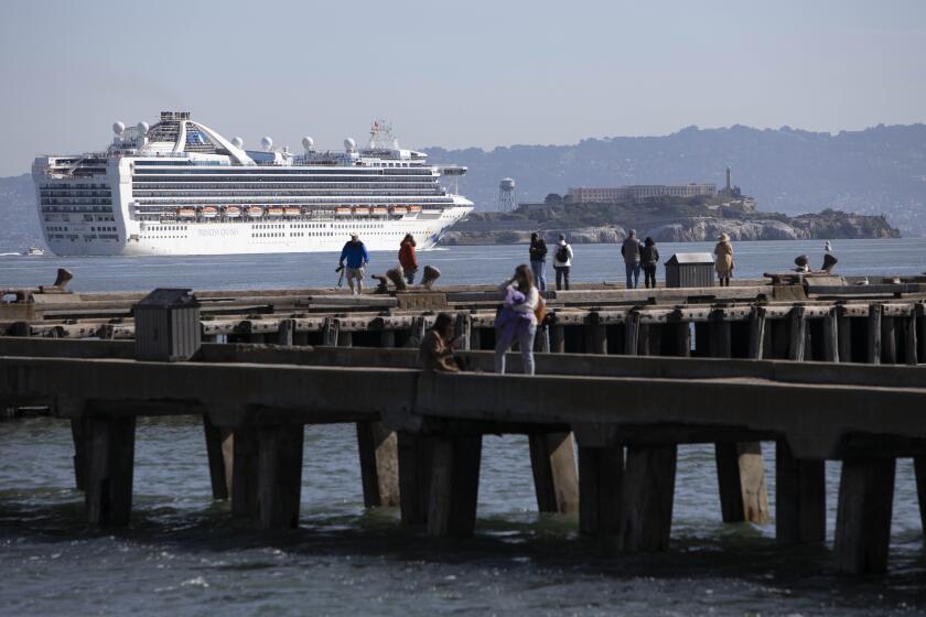 SAN FRANCISCO CA. MARCH 9, 2020 - The Grand Princess cruise ship sails past Alcatraz Island to dock at the Port of Oakland to off it's passengers to be screened for the COVID-19 virus, San Francisco, CA, USA 9 Mar 2020. (Peter DaSilva / For The Times)