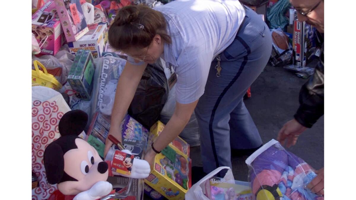 Postal employees organize gifts at the North Hollywood office of the Department of Children and Family Services before they're delivered to needy children for Christmas in 2001.