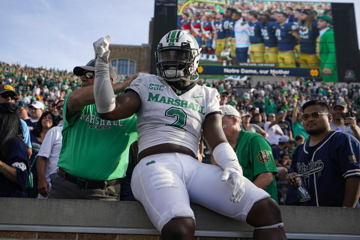 Marshall defensive lineman Elijah Alston celebrates with fans after a 26-21 win at Notre Dame on Sept. 10, 2022.