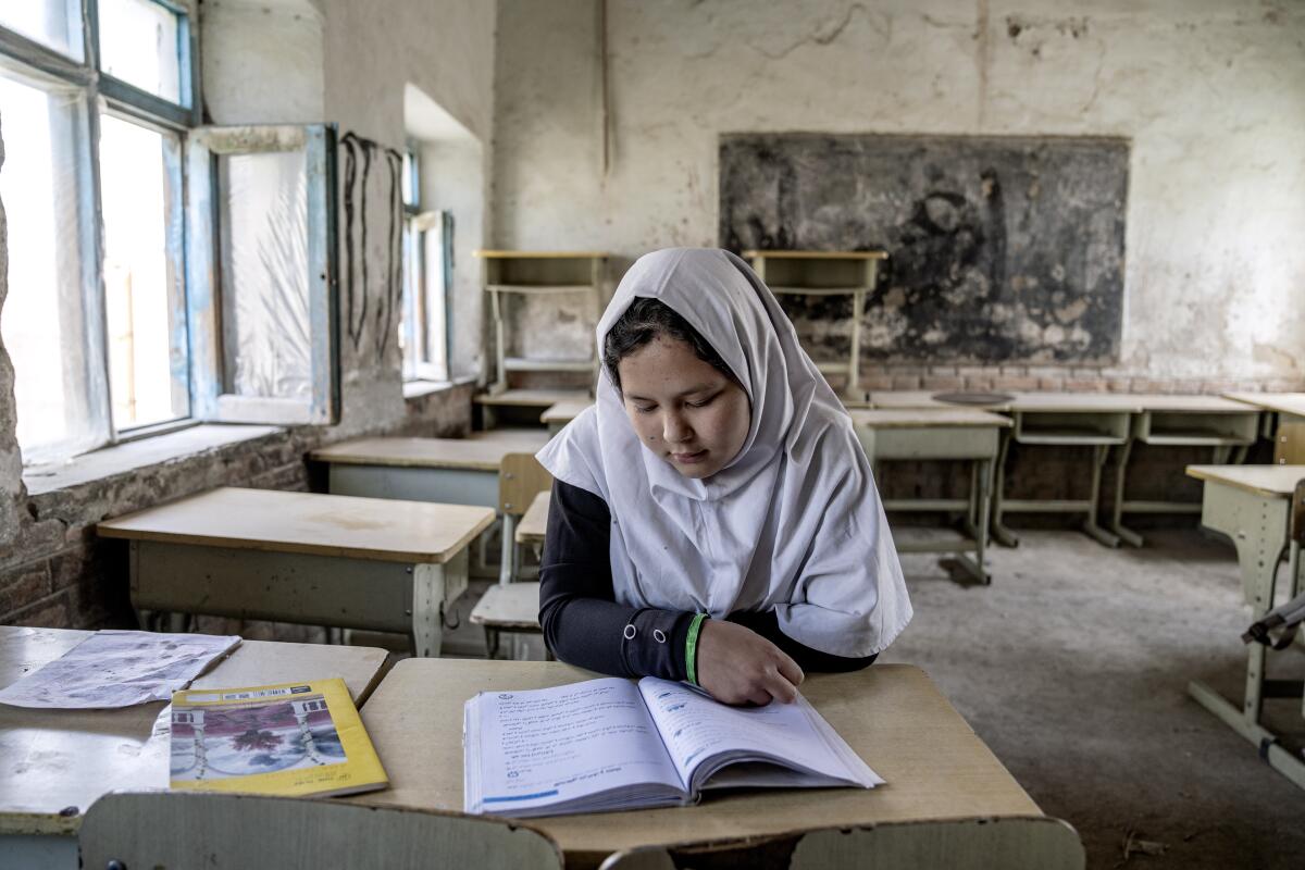 A girl reads in her classroom in Kabul.