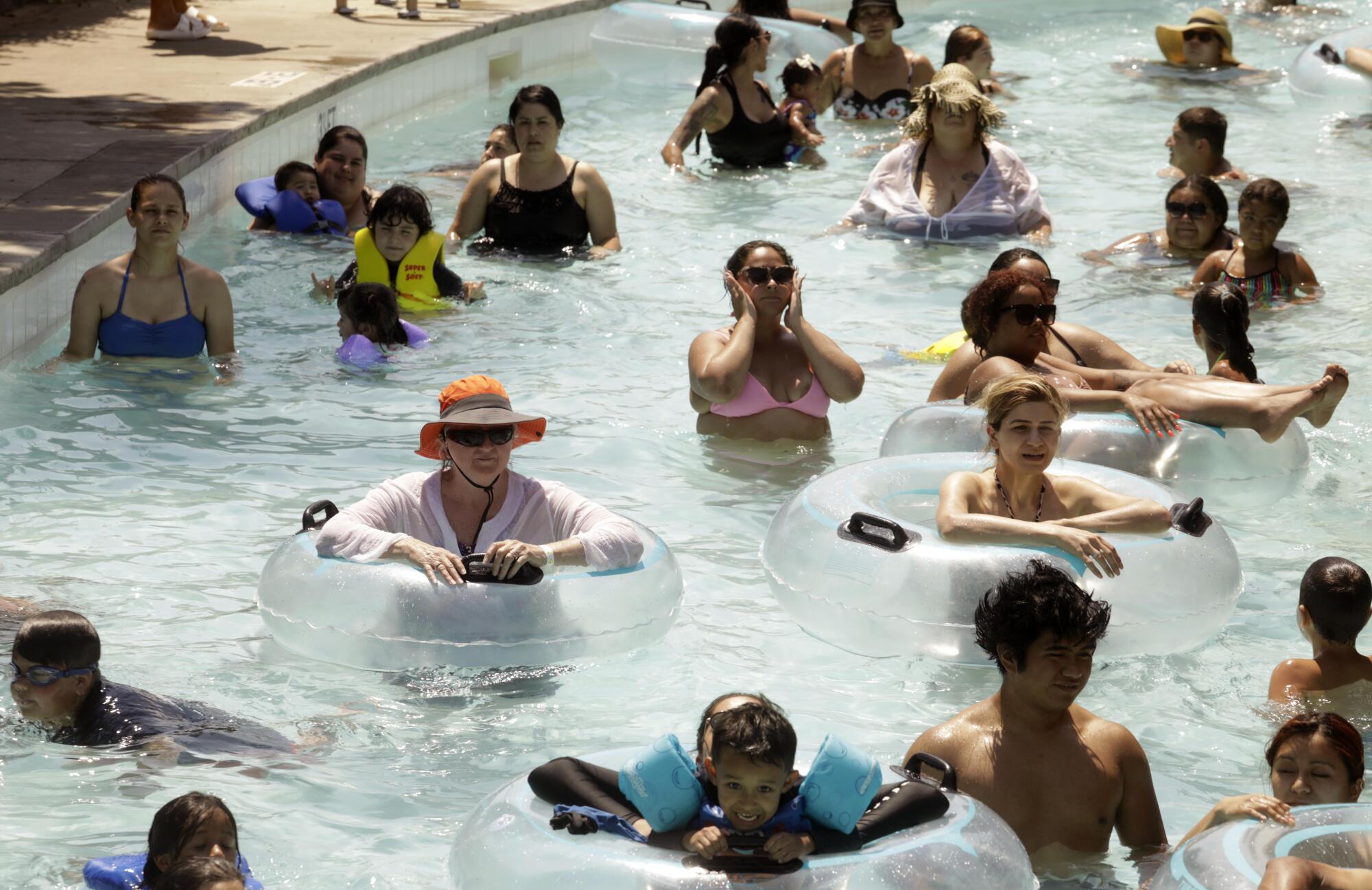 People cool off at Dry Town Water Park where temperatures reached 108 degrees by 3 p.m. in Palmdale on Sunday.