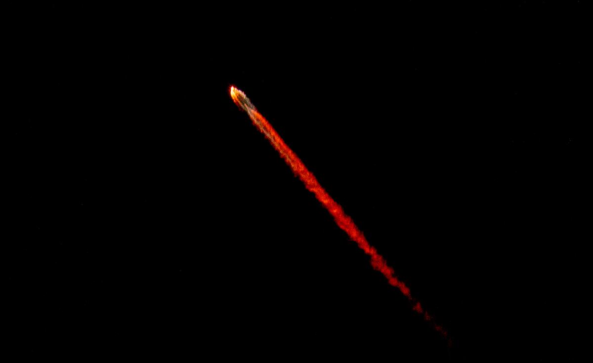 A long streak of red against a black background.
