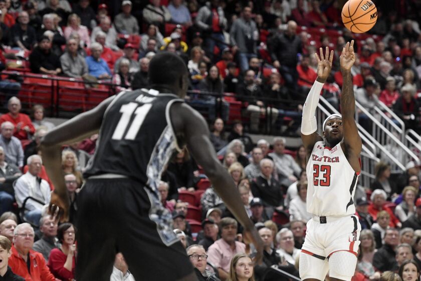 Texas Tech guard De'Vion Harmon (23), right, shoots the ball against Georgetown during an NCAA college basketball game, Wednesday, Nov. 30, 2022, at United Supermarkets Arena in Lubbock, Texas. (Annie Rice/Lubbock Avalanche-Journal via AP)