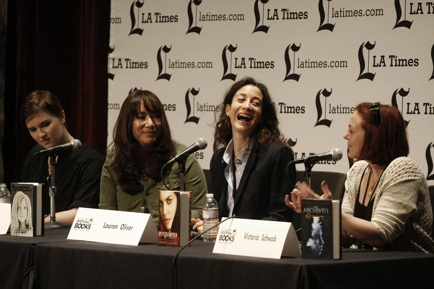 Lauren Oliver laughs with fellow young adult authors, from left, Veronica Roth, Lissa Price and Victoria Schwab.
