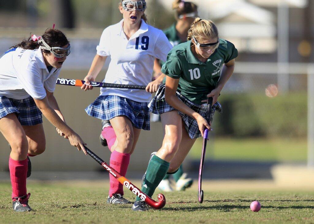 Edison High's Rachel Bryan (10) keeps the ball away from Newport Harbor's Riley Flanagan, left, during the second half in a Sunset League game at Davidson Field on Tuesday.