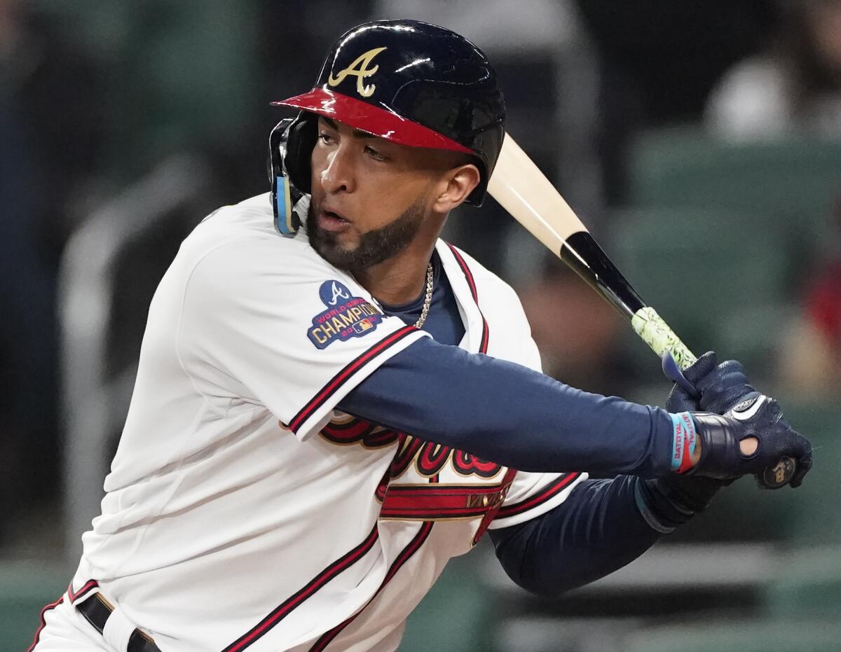 FILE - Atlanta Braves' Eddie Rosario bats against the Cincinnati Reds during a baseball game April 8, 2022, in Atlanta. Rosario has been activated from the injured list and is starting in left field against the St. Louis Cardinals on Monday, July 4, 2022. (AP Photo/John Bazemore, File)