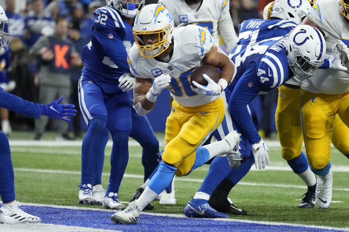 Chargers' Austin Ekeler (30) runs for his first of two touchdowns against the Colts. 