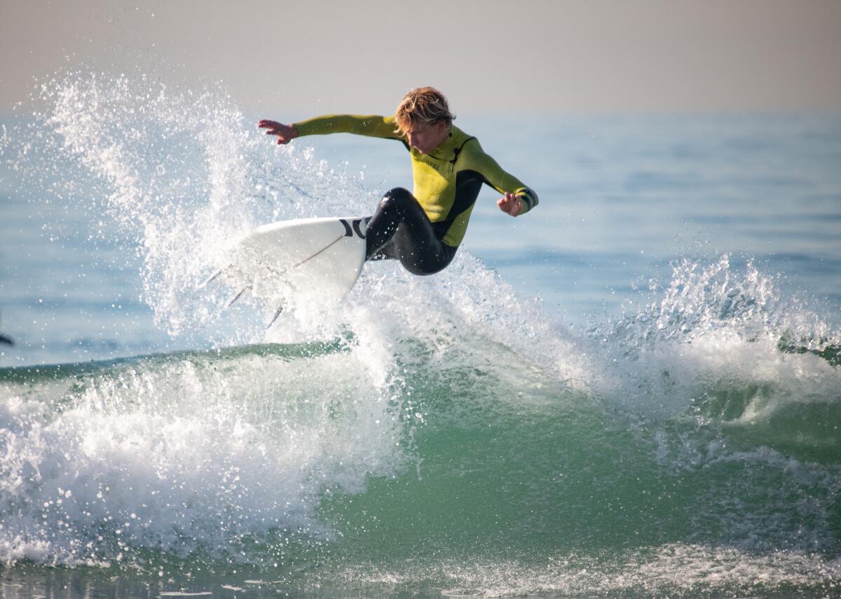 Costa Mesa surfer Quaid Fahrion flies over a small wave.
