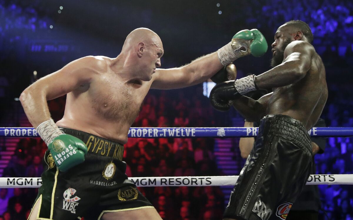Tyson Fury throws a punch at Deontay Wilder during their WBC heavyweight title match Feb. 22, 2020, in Las Vegas.