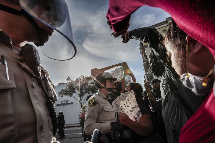 Santa Monica, CA, Sunday May 31, 2020 - Protestors face off with police downtown as unrest continues in the wake of the death of George Floyd in Minneapolis. (Robert Gauthier / Los Angeles Times)