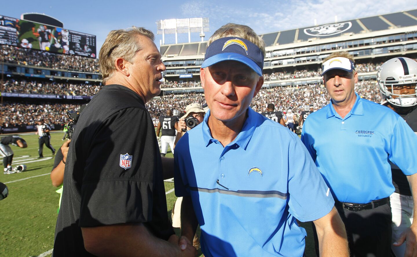 San Diego Chargers coach Mike McCoy meets with Raiders coach Jack Del Rio after a 34-31 loss to the Raiders in Oakland on Oct. 9, 2016. (Photo by K.C. Alfred/The San Diego Union-Tribune)