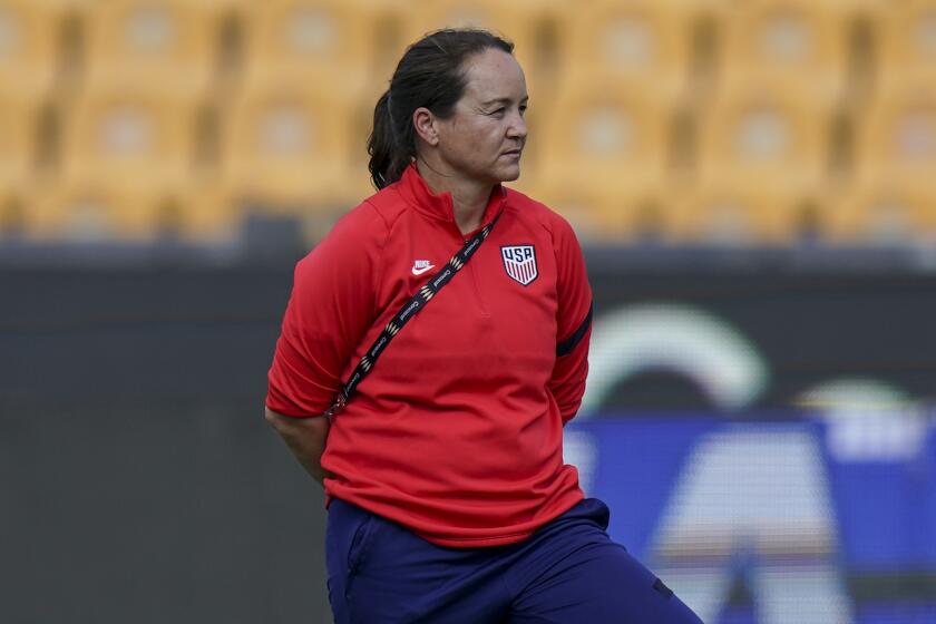 Twila Kilgore, assistant coach on the U.S. team watches players warm up prior to a CONCACAF.
