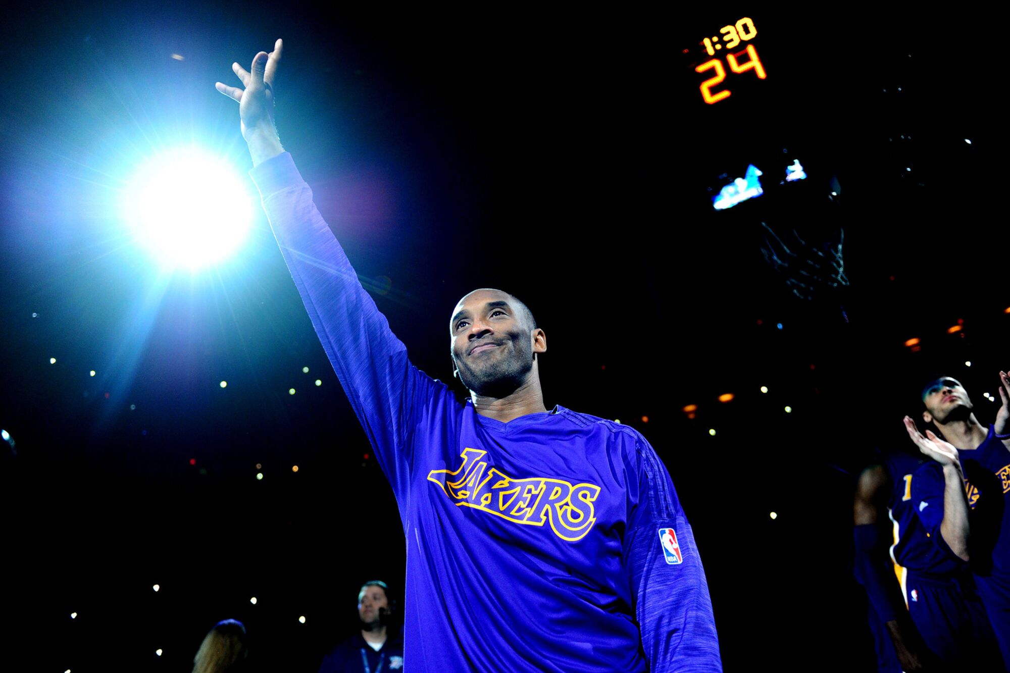 Kobe Bryant waves to the crowd as he is introduced before a game.