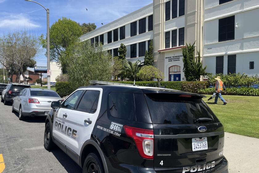 School police parked in front of Washington Preparatory High School in South L.A. and increased neighborhood patrols after one student fatally shot another after school on April 15 outside a nearby convenience store.