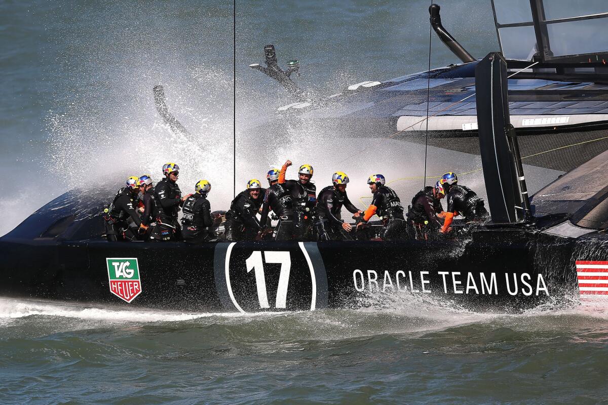 Oracle Team USA skippered by James Spithill celebrates after finishing ahead of Emirates Team New Zealand skippered by Dean Barker during race 18 of the America's Cup Finals on September 24, 2013.