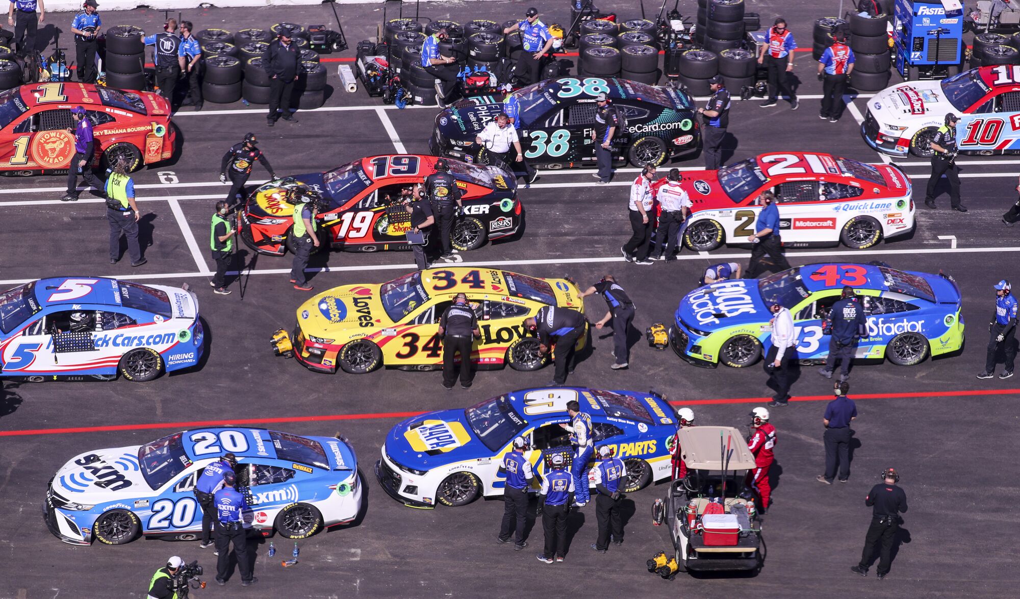 Drivers and their crews prepare to race in the Busch Light Clash At The Coliseum