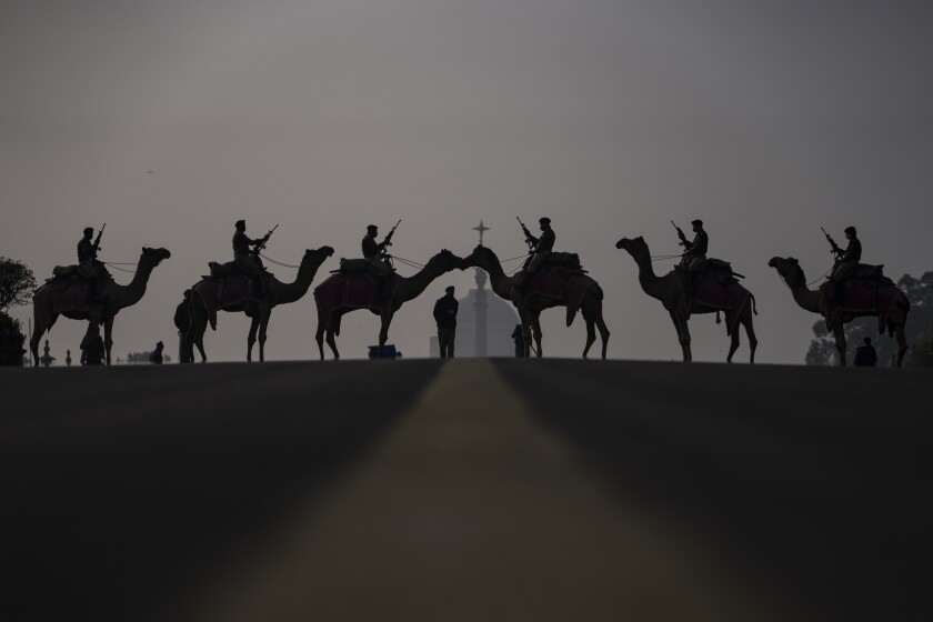 Camel-mounted soldiers stand in formation during rehearsals for the upcoming Beating Retreat ceremony at Raisina hill which houses India's most important offices and the presidential palace in New Delhi, India, Wednesday, Jan. 19, 2022. The ceremony held annually on Jan. 29 marks the end of Republic Day festivities. (AP Photo/Altaf Qadri)