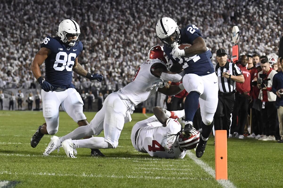 Penn State running back Keyvone Lee (24) is tackled by Indiana linebacker Cam Jones (4) in the first half of their NCAA college football game in State College, Pa., on Saturday, Oct. 2, 2021. (AP Photo/Barry Reeger)