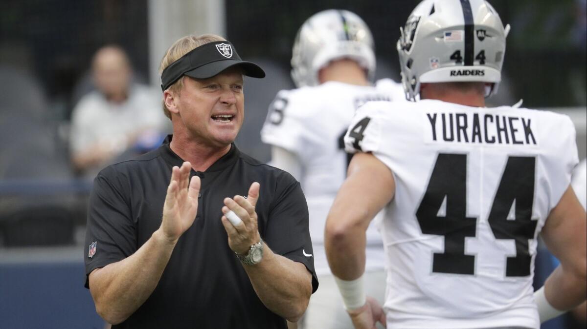 Oakland Raiders head coach Jon Gruden calls to his team as he stands next to running back Ryan Yurachek before a preseason game against the Seattle Seahawks on Aug. 30.