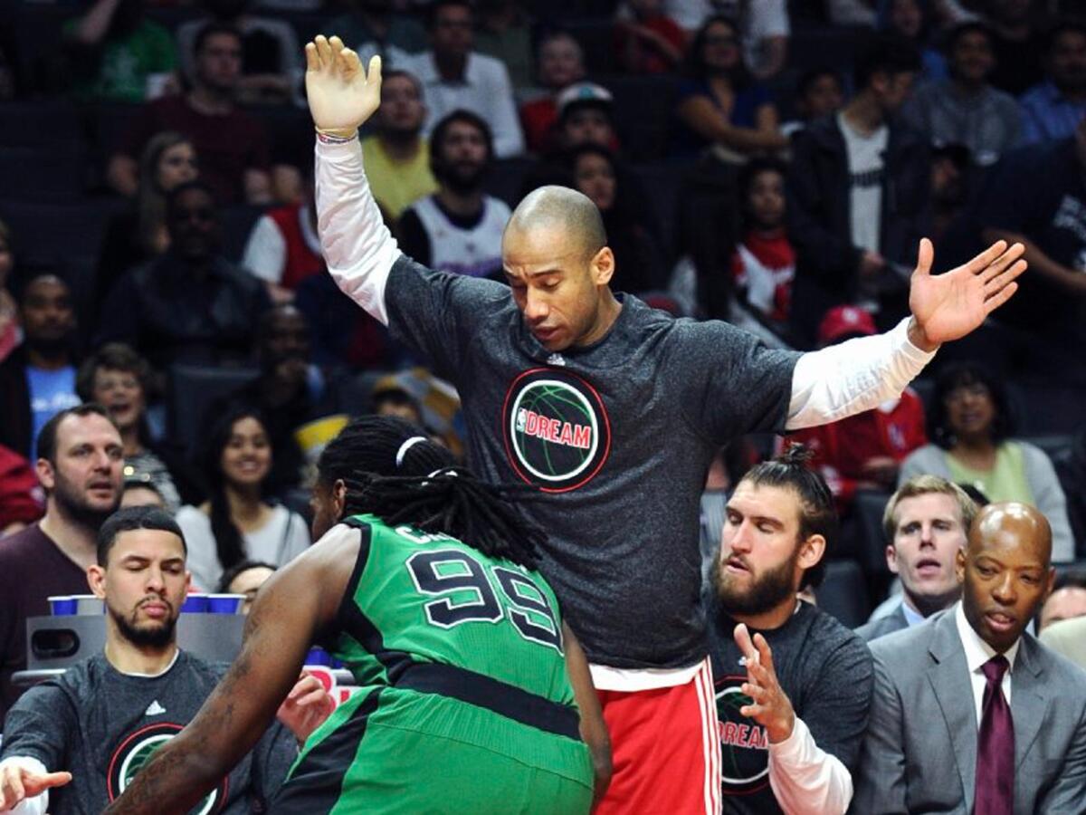 Clippers guard Dahntay Jones tries to get out of the way of Celtics forward Jae Crowder as he chases a loose ball out of bounds during a game Jan. 19 at Staples Center.