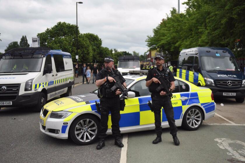 Armed police officers secure the area as revellers arrive to attend the Courteeners concert at Old Trafford cricket ground in Manchester, northwest England, on May 27, 2017. Security around Old Trafford cricket ground was enhanced after organisers went ahead with the Courteeners concert less than a week after 22 people were killed in a suicide blast at the Manchester Arena. / AFP PHOTO / Oli SCARFFOLI SCARFF/AFP/Getty Images ** OUTS - ELSENT, FPG, CM - OUTS * NM, PH, VA if sourced by CT, LA or MoD **