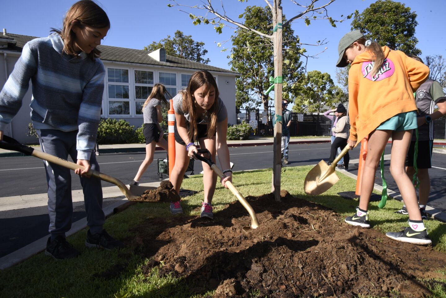 Alexandra, Carlin and Isabella plant a tree on Earth Day