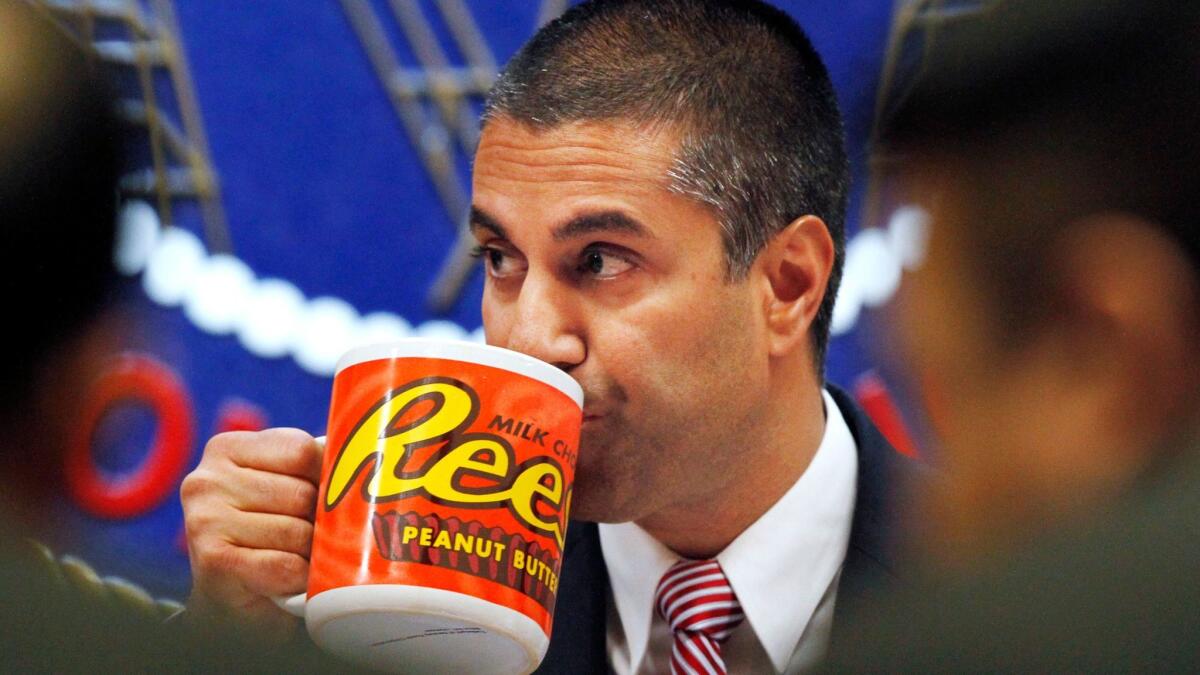 Federal Communications Commission Chairman Ajit Pai drinks from a giant mug during a December meeting where the FCC voted on net neutrality. Burger King had a similar mug in its net neutrality ad.