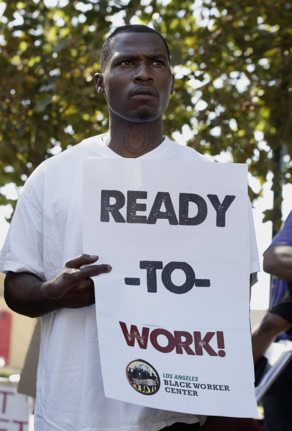 Arthur Gosey participates in a "ready to work" rally held by the Los Angeles Black Worker Center last year at Leimert Park. A new report released Thursday pointed out that blacks were falling behind whites and Latinos when it came to employment and income.