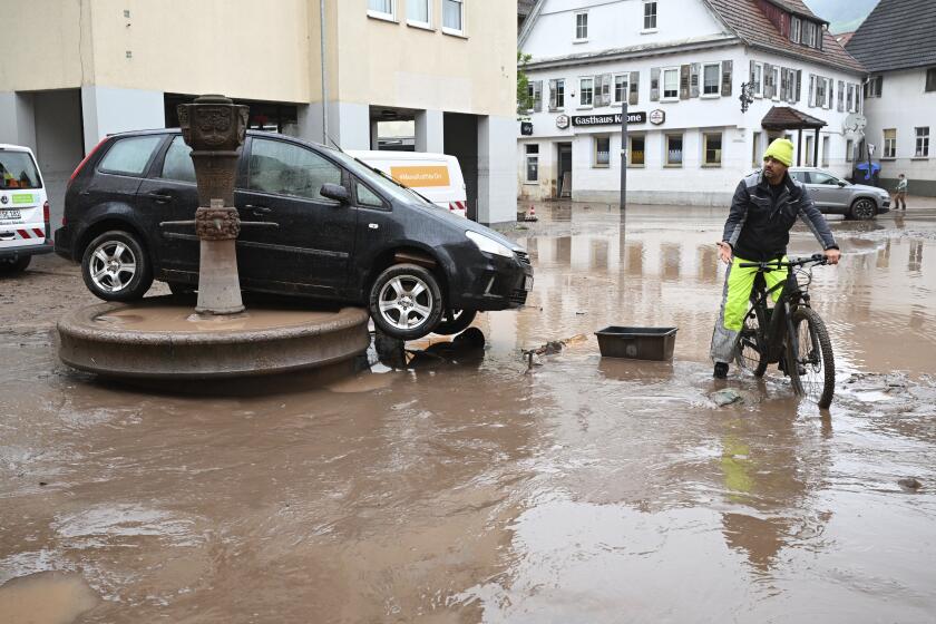 A car washed away by floodwater rests on a well, in Rudersberg, Germany, Monday, June 3, 2024. Persistent heavy rain led to widespread flooding in the southern states of Bavaria and Baden-Wuerttemberg over the weekend. (Bernd Wei'brod/dpa via AP)