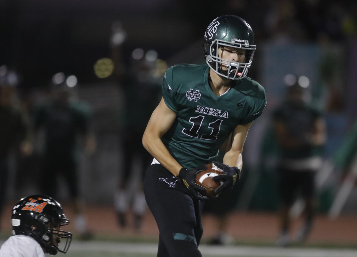 Costa Mesa receiver Riley Weinstein makes a catch and heads upfield.