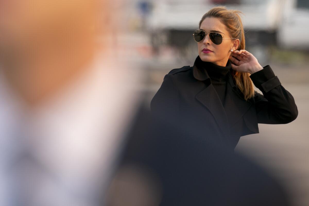 Hope Hicks in sunglasses and a black overcoat 