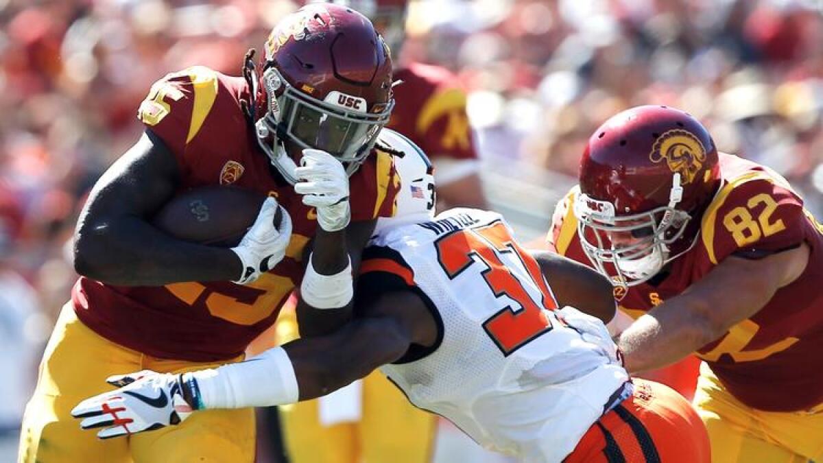 USC running back Ronald Jones II, left, runs through Oregon State linebacker Kee Whetzel with Trojans tight end Tyler Petite blocking on Oct. 7.