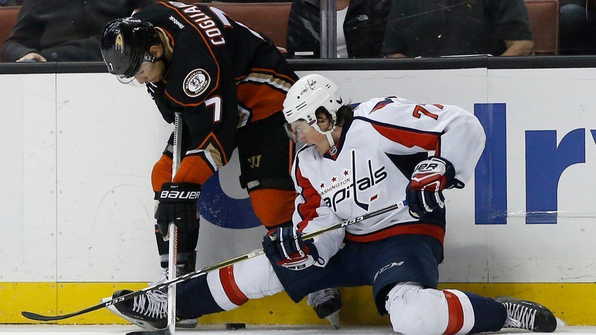 Washington Capitals right wing T.J. Oshie, right, protects the puck from his knees against Ducks left wing Andrew Cogliano during the second period Sunday.