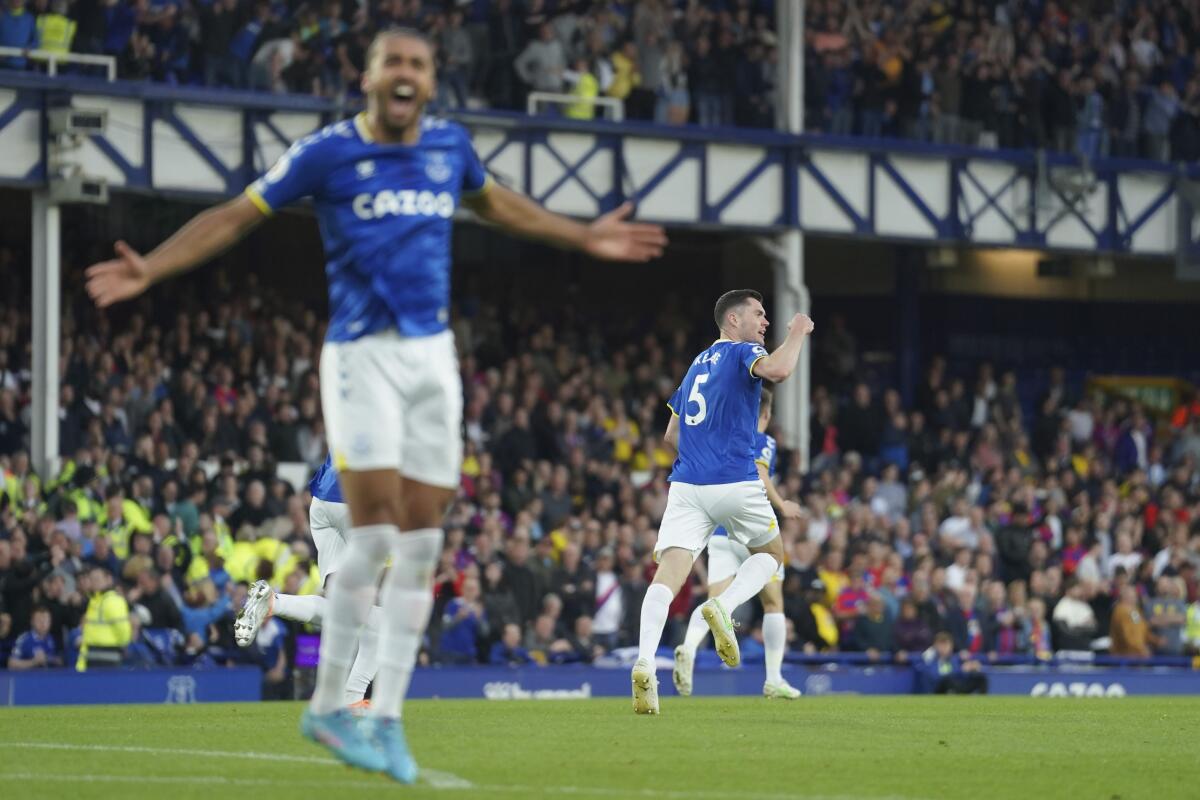 Everton's Michael Keane, right, celebrates after scoring against Crystal Palaceduring the English Premier League soccer match between Everton and Crystal Palace at Goodison Park in Liverpool, England, Thursday, May 19, 2022. (AP Photo/Jon Super)